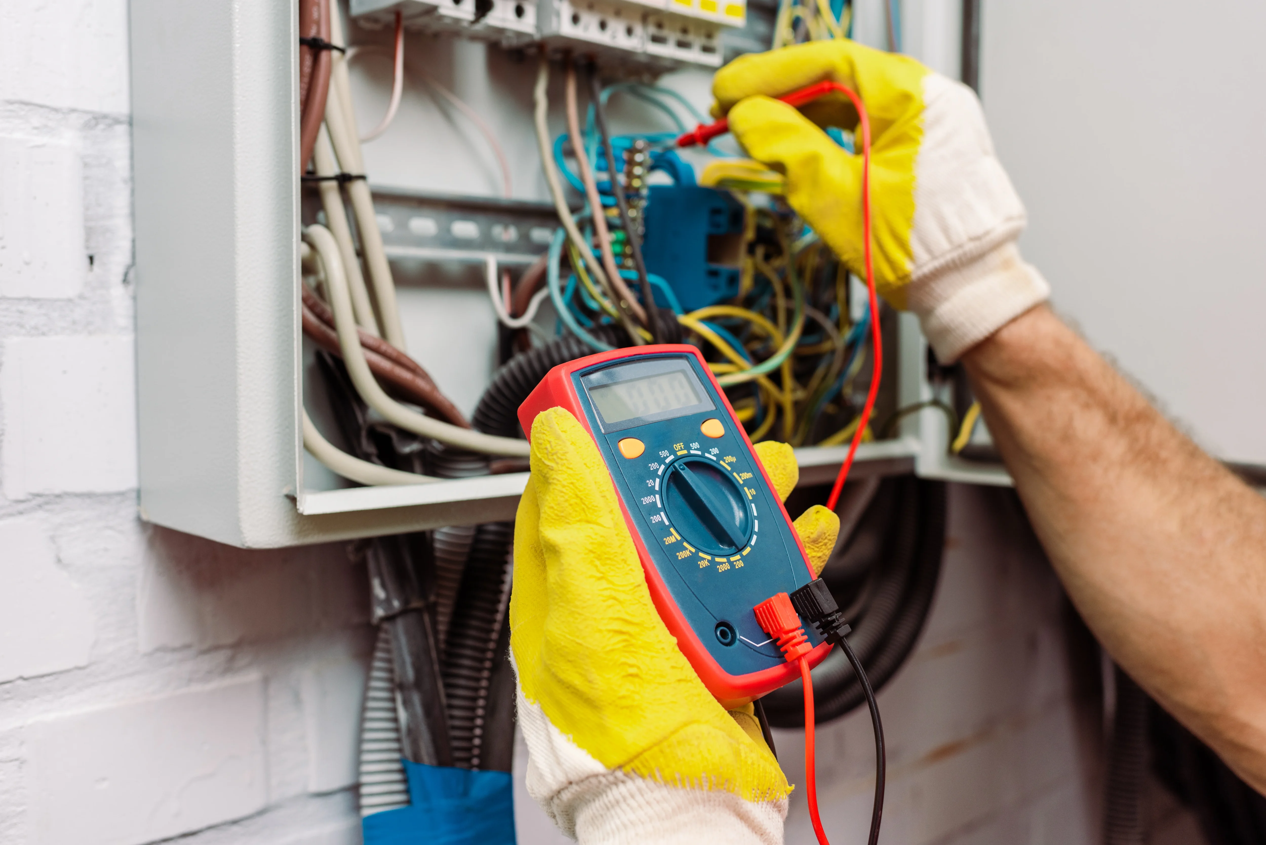 cropped-view-of-workman-in-gloves-using-multimeter-2022-06-23-14-58-15-utc